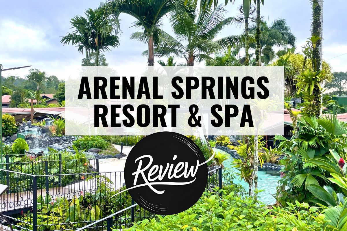 a hotel property with pools palm trees and gardens with text overlay that reads arenal springs resort and spa review