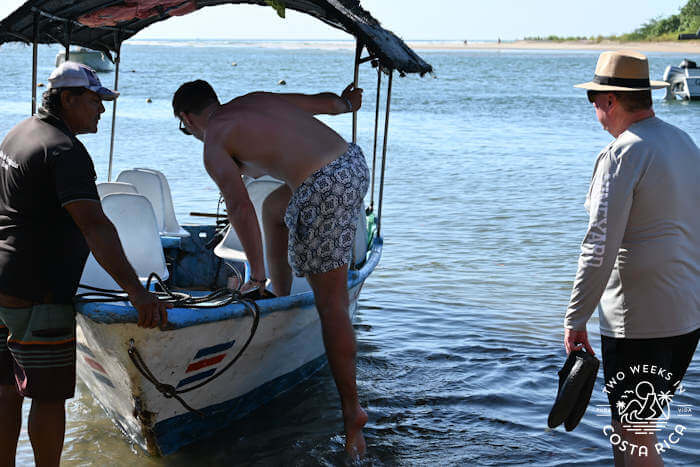 Several men boarding a small boat