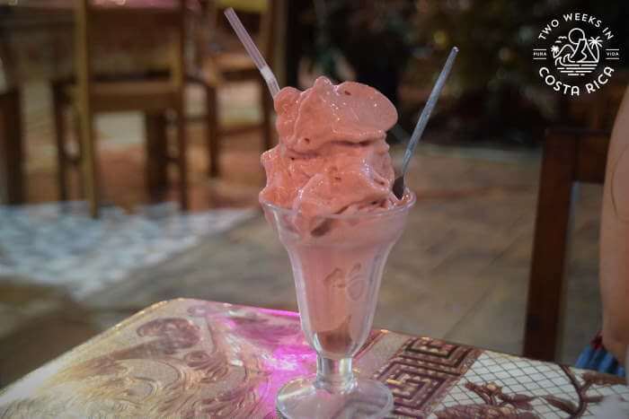 pink frozen smoothie in a tall glass dish