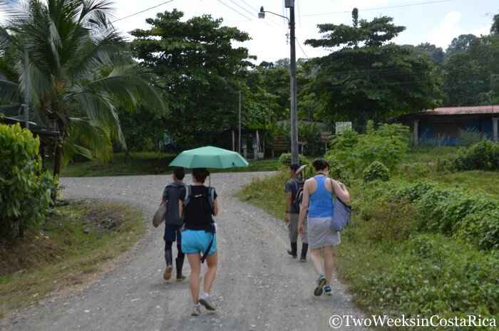 Tourists walking through the town of Dos Brazos near Puerto Jimenez Costa Rica