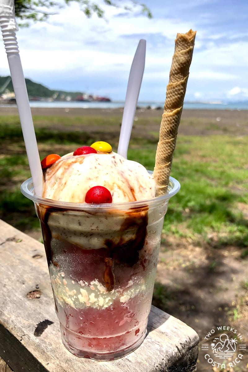 a granizado ice cream with caldera beach in the background