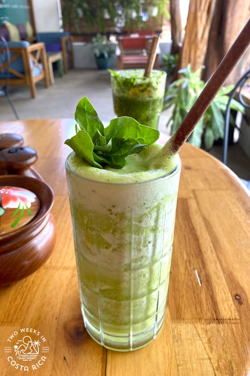 green drink with mint sitting on a table
