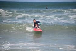 a kid riding a wave at playa guiones nosara