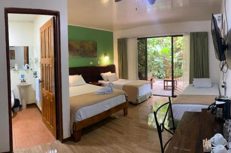 a deluxe room at Tirimbina Lodge with two full beds and a rainforest view