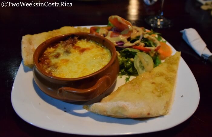 plate of food with cheesy soup bread and salad