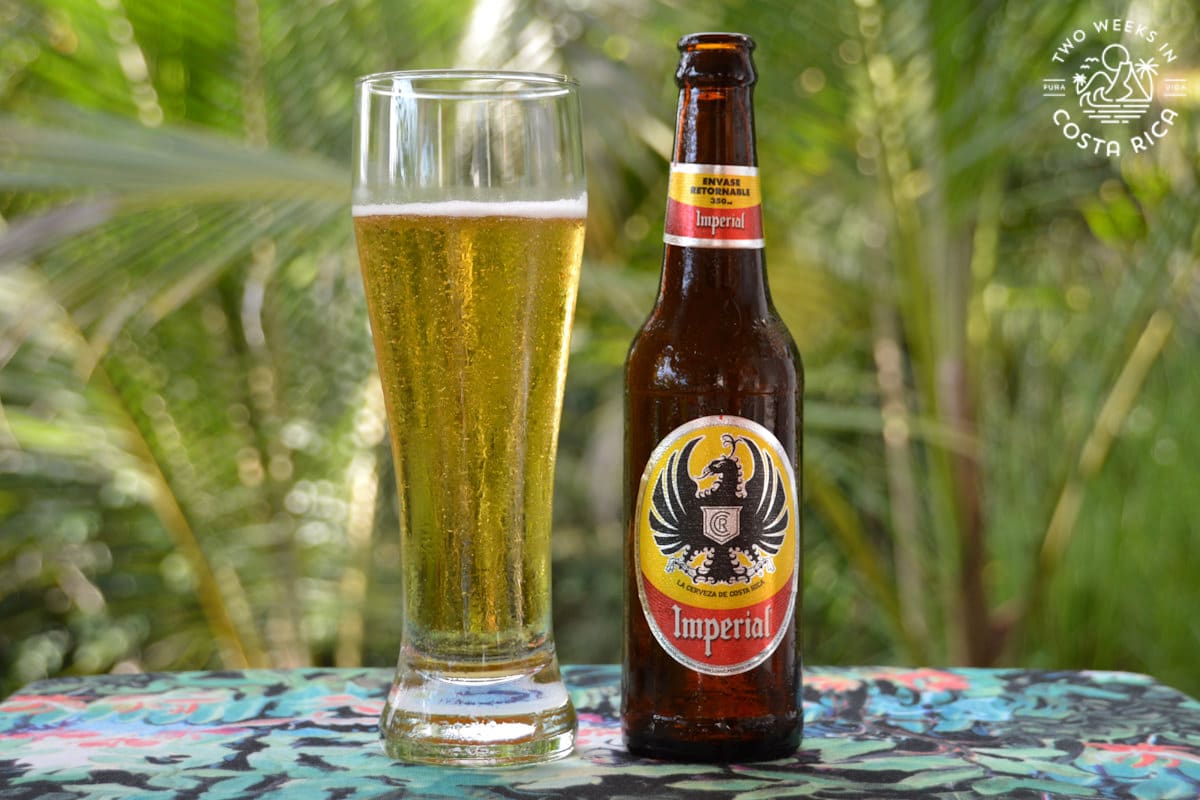 Bottle of Imperial Beer displayed next to a beer glass filled with Imperial