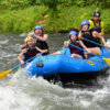 Family with younger kids rafting on river