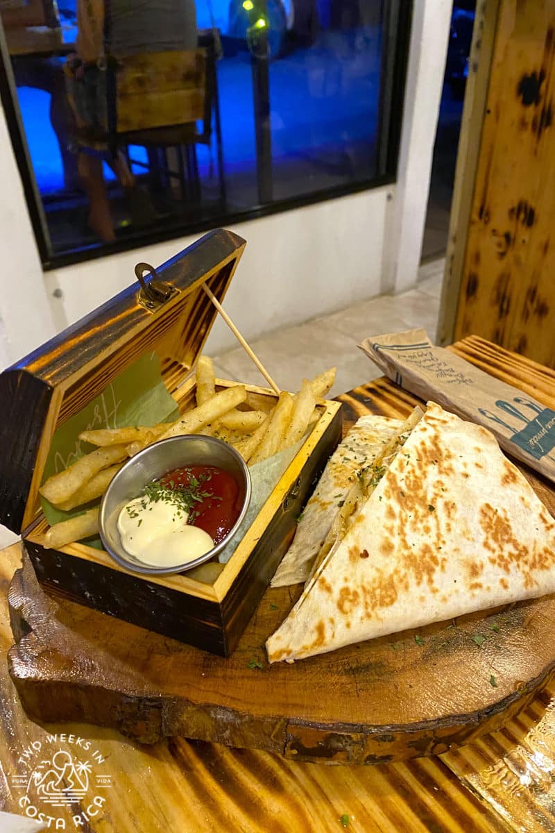 french fries in a wooden box with quesadillas