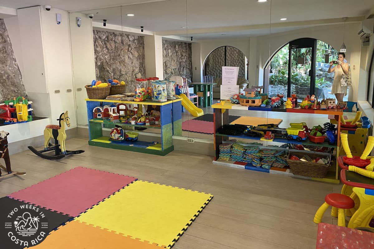 room with colorful floor mats and toys for kids