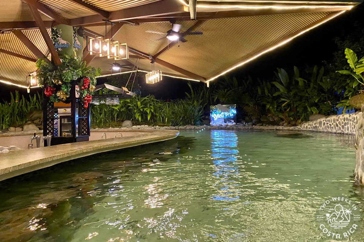 a large pool with a bar at night