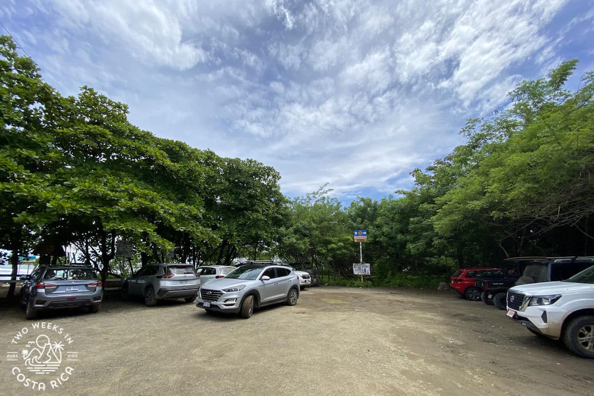 cars parked in the lot at playa guiones