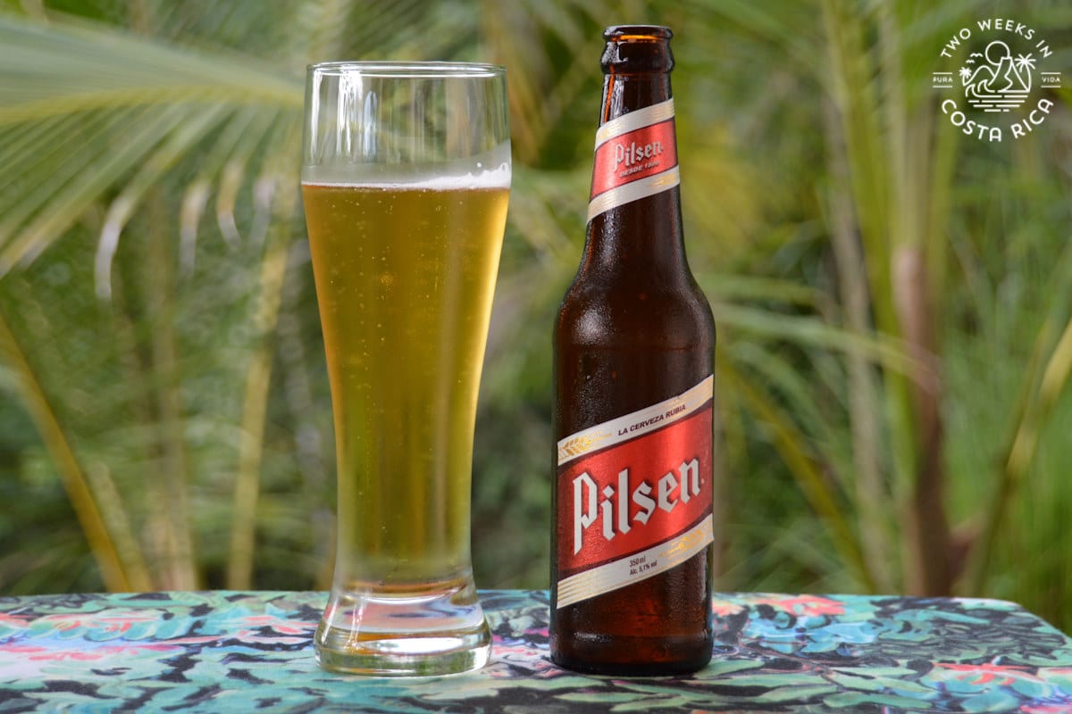 Bottle of Pilsen Beer displayed next to a beer glass filled with Pilsen
