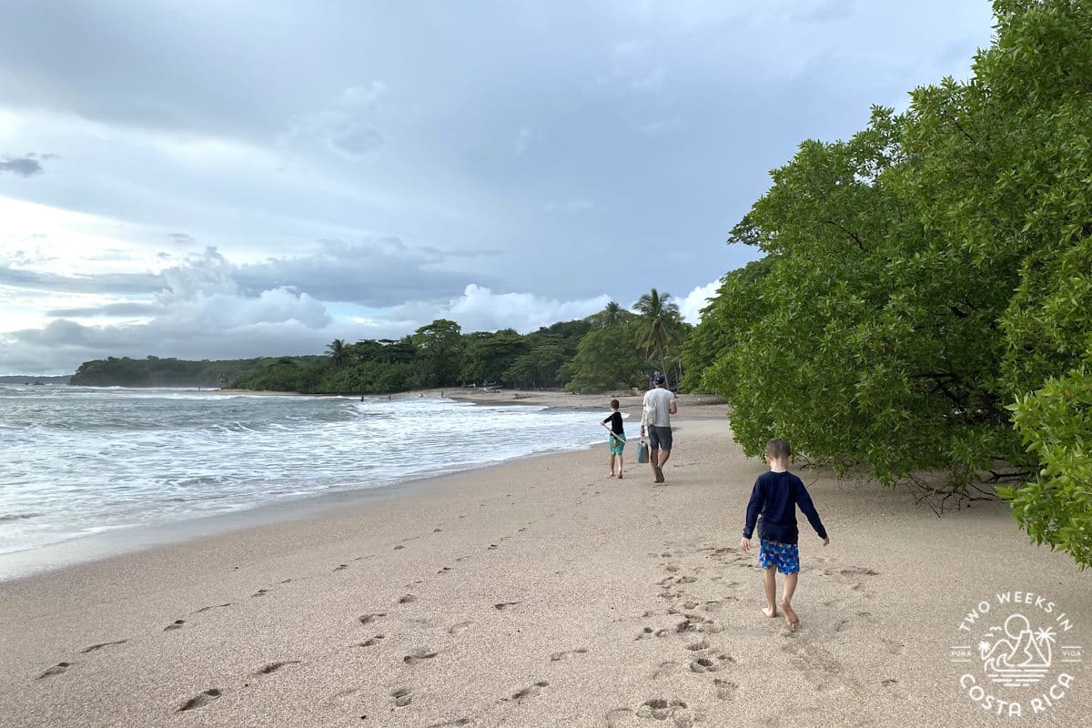 a family walking on the beach at playa pelada