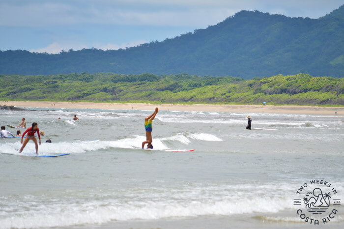 person riding a surfboard on his head in the ocean