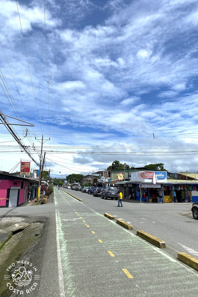 a street with bike lane and some small businesses