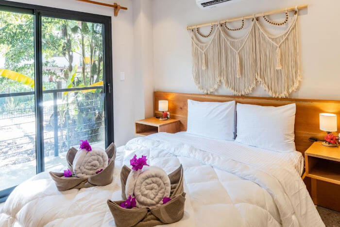 bed with white sheets and macrame decoration