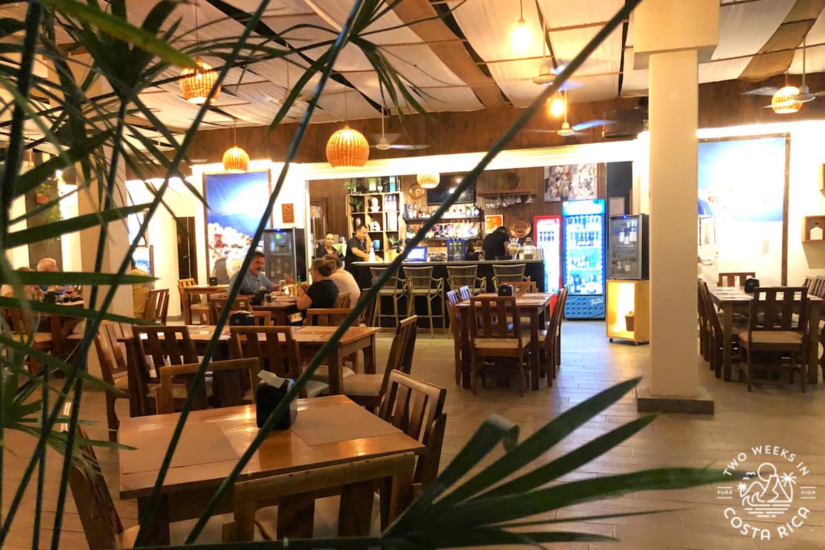 The inside of a restaurant showing tables and low lighting