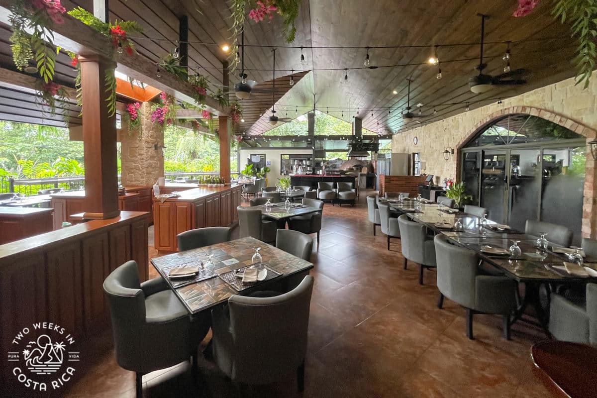 a restaurant with tables and a garden view