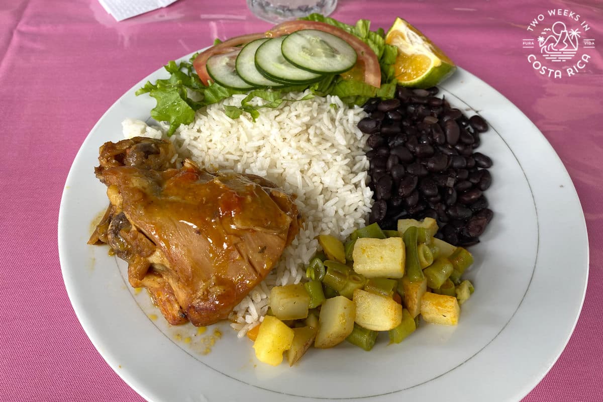 a plate of food with chicken rice beans and salad