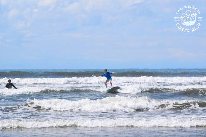 A kid surfing at Playa Chaman in Uvita