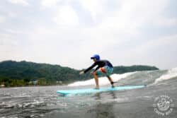 a kid riding a wave in jaco costa rica
