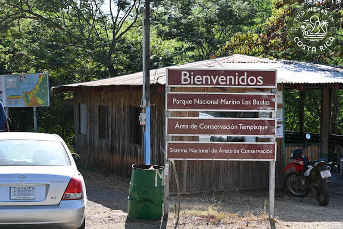 A national park sign indicating the meeting point for Tamarindo Estuary boat tours