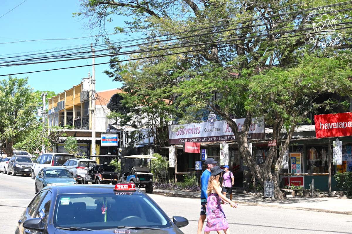 people walking on a street in tamarindo costa rica with many businesses