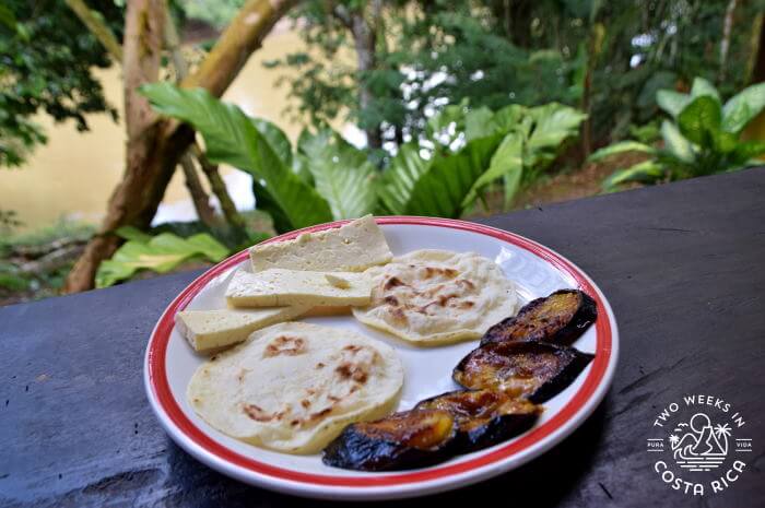 A plate with sliced cheese, tortillas, and fried plantains from our river float tour in La Fortuna, Costa Rica