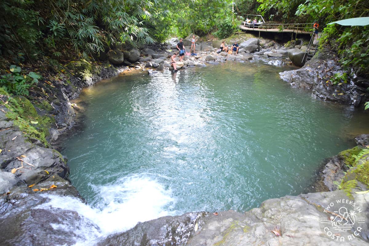 wide pool of water surrounded by rocks